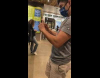 Guy grey shirt blue cap on table