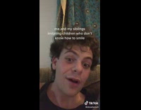 Graduation picture siblings smiling awkwardly 