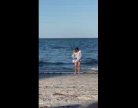 Girl grey sleeves sit selfie windy beach