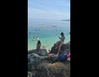 Collab IITW - Woman red bikini sit on rocks beach