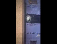 McDonalds drive thru sign with broken glass bullet hole