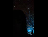 Girl at music event reacting to blue lasers