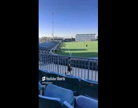 Boy poses with soccer field behind him