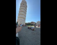 Man lie down for Pisa tower photo