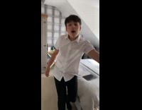 Kid in white dress shirt yells at brother