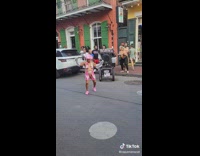 Elderly woman dances in pink 