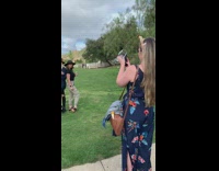 Three girls wine glasses hats grass field