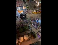 Lots of cyclist with lights gathered on street