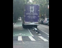 Truck runs over bollards on street 