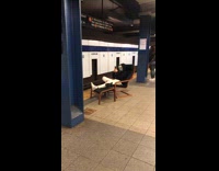Guy sits on chair at subway station 