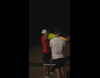 2 guys light a firework in a cone 