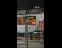 Girls film and sing inside train night