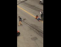 Guy ride skateboard photographer lay middle street