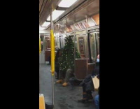 Guy is wearing christmas tree on subway 