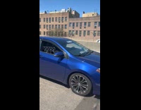 Multiple large speakers inside blue car highway