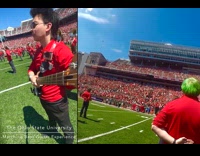 Man plays bass guitar on a marching band that performed in the arena