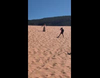 Woman hat grey skirt throw sand sunny