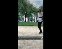 Two people in New York park fencing each other 