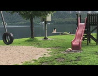 Woman dress sit on plank lake slide