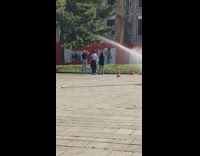 Woman stand grass sprinkler photo shoot park