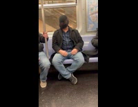 Man hide face while travel inside train in NYC 