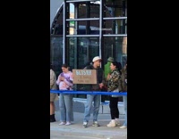 Man hold sign about blister at Marathon