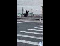 Man raise hands while talking on street