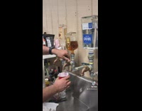 Guy pouring drink from homemade alcohol dispensers