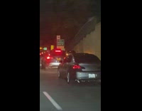 Car Spits Fire From Exhaust Pipes on Freeway 