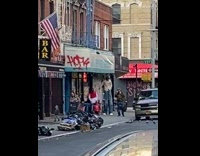 Tall man walks along the street at day in NY 