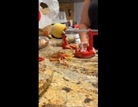Woman using fruit peeler machine 