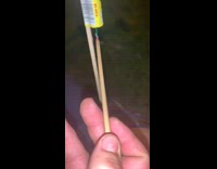 Guy lights a firework in between his buttcheeks while laying on the grass, firework falls over and explodes