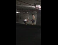 Man shirtless poses and reviews photo at the parking lot