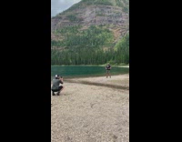 Guy black shirt show belly lake trees