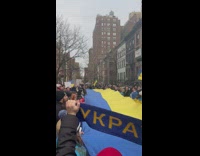 people hold Ukranian flag and sing together