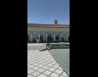 Guy taking overhead picture of friend on ground readjusts her head