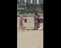 Woman pink bikini cap dance beach tripod