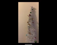 White Christmas tree wiggling and then falls apart and collapses 