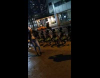 Woman takes picture sidewalk