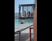 women pose for poolside bikini photos