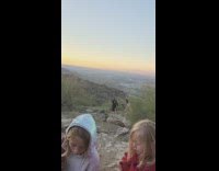 Woman in black dress music video shoot at the mountains