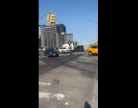 Man on bike balancing tire on head 