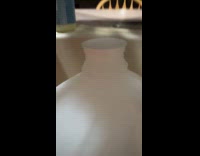 Milk jug lid moves up and down