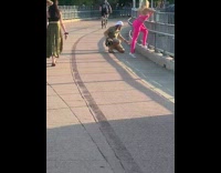 Woman pink leggings lean metal railings dog