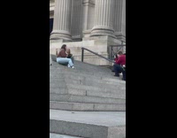 Two women talks and poses at the stairs