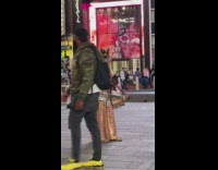 Old Lady Wears Gold Dress with Tons of Instruments and Hats 