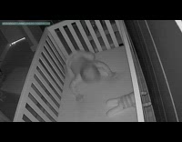 Baby boy lays down pretends to sleep