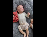 Baby laughs on blue cushion 