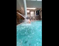 Man goofing around at spa while girlfriend relaxes 