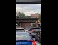 Man sits on hood of moving car